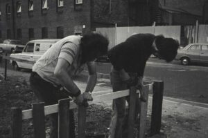 Fence construction on the community garden to stop people parking on it, 1974
