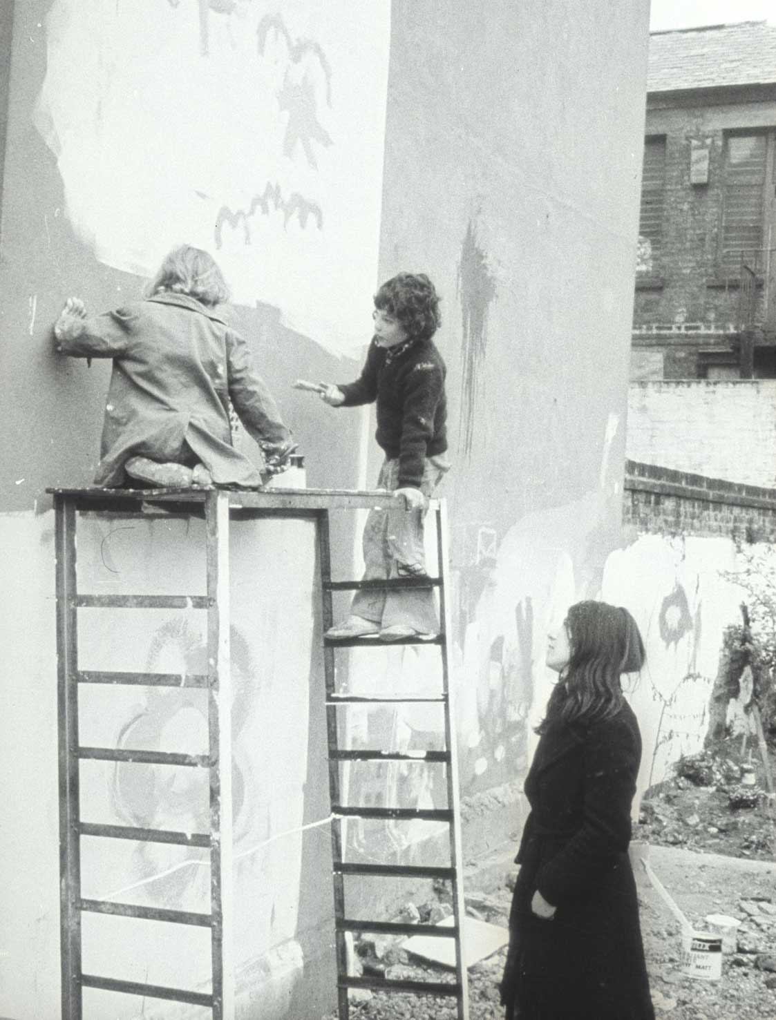 Painting a mural at the community garden, 1974