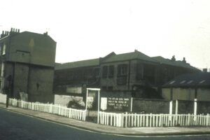 Picket fencing around the community garden to stop car parking, 1974